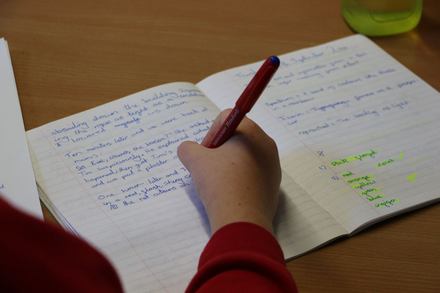A child writes in their workbook